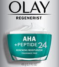 Olay Regenerist AHA + Peptide 24 moisturizer jar on a gray background
