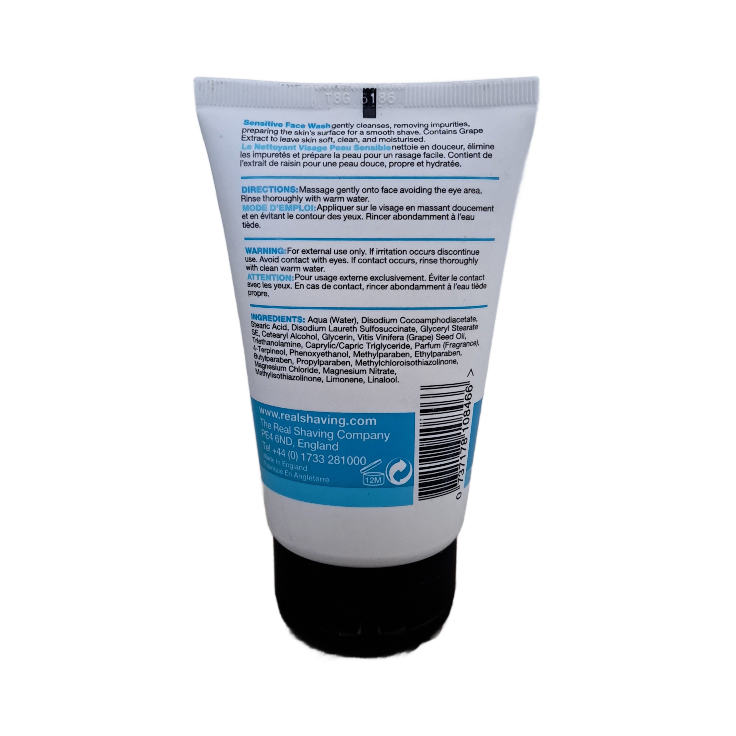 Back view of a shaving cream tube with text and branding on a white background