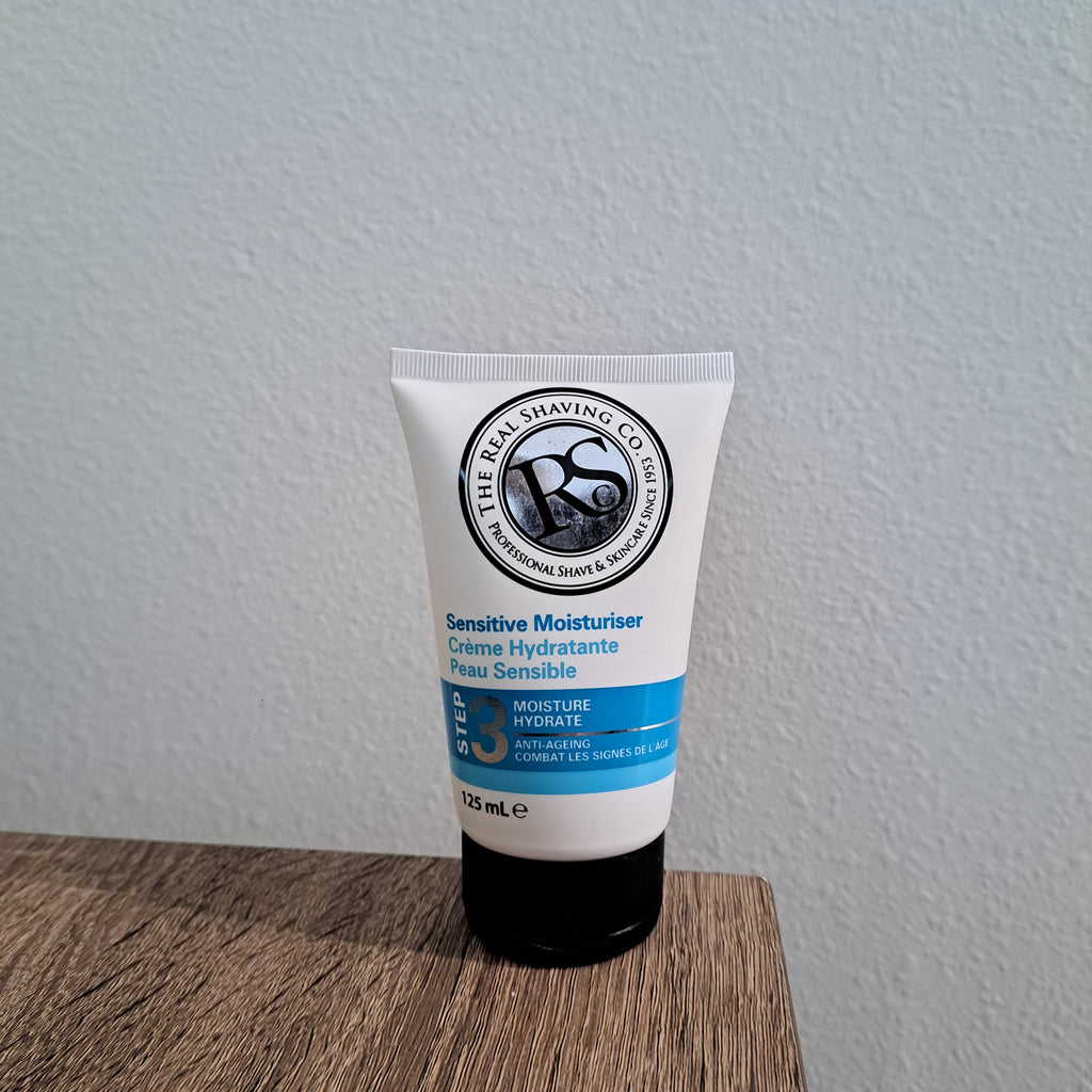 Tube of sensitive moisturizer on a wooden surface with a gray background