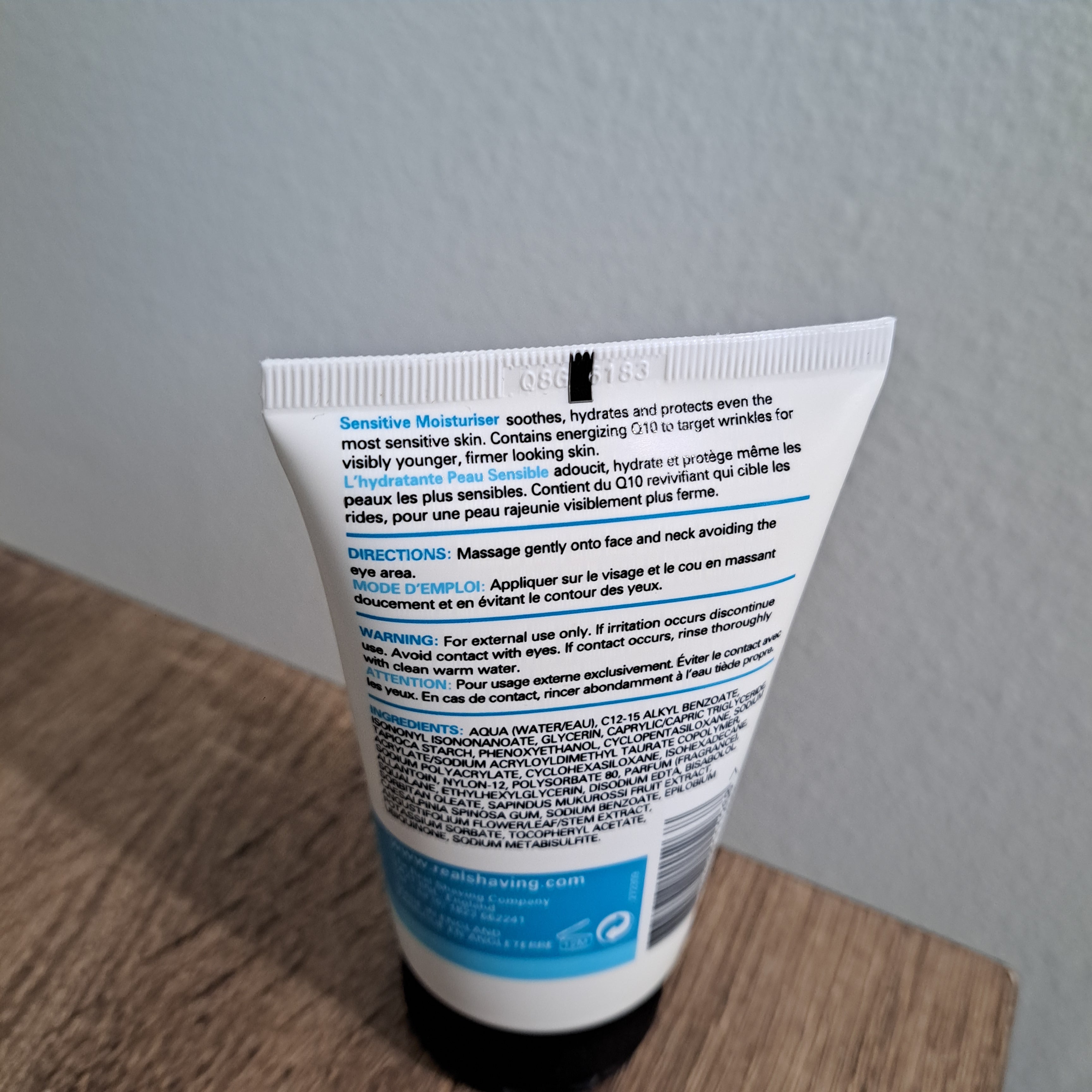 Tube of cream with label on a wooden surface