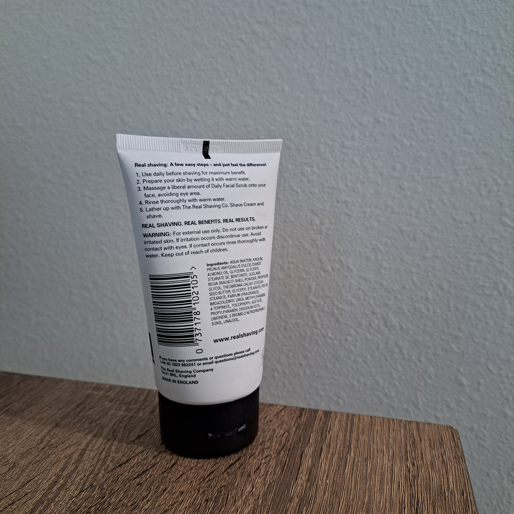 Tube of cream on a wooden surface with a light gray wall background