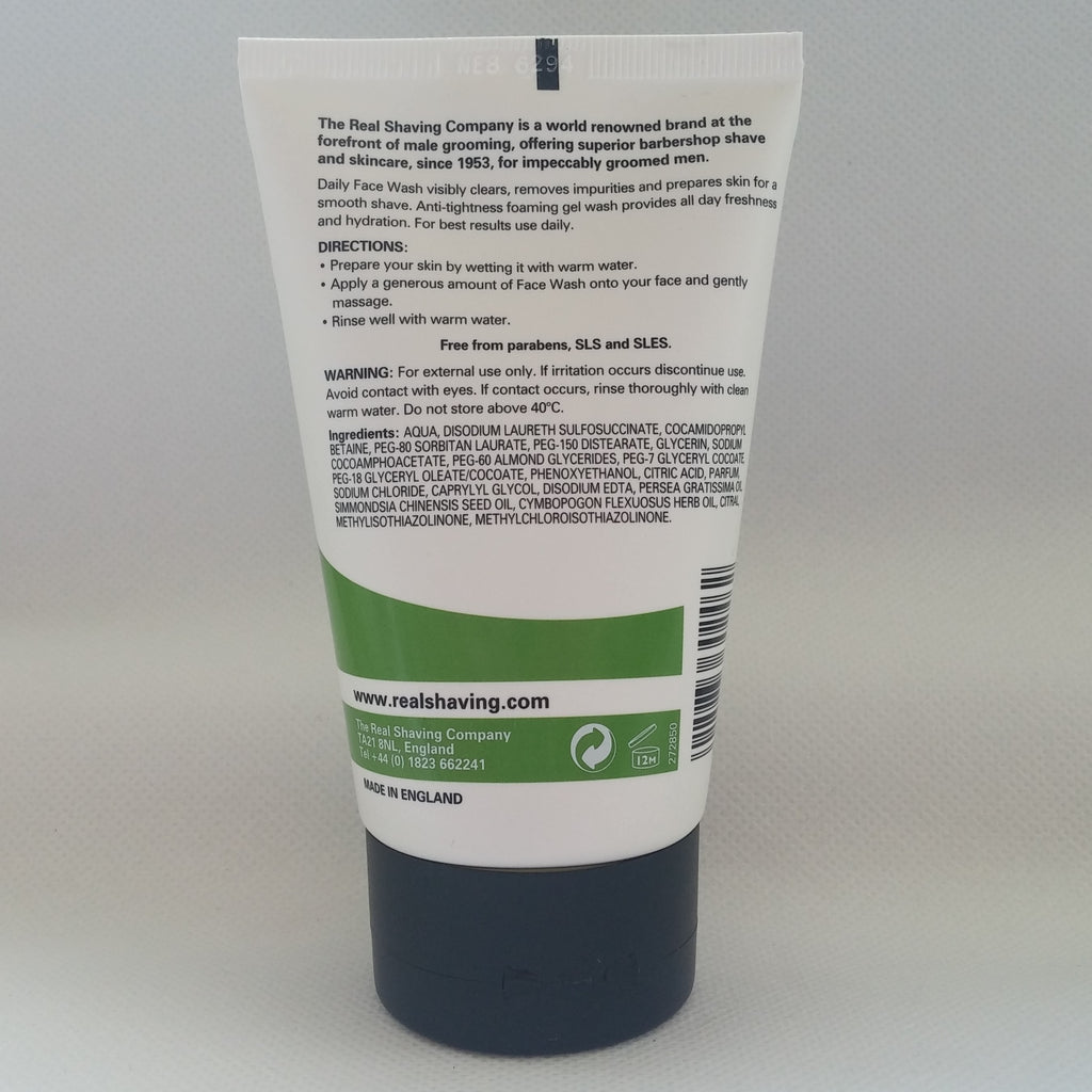 Back label of a shaving product tube with text and branding on a gray background